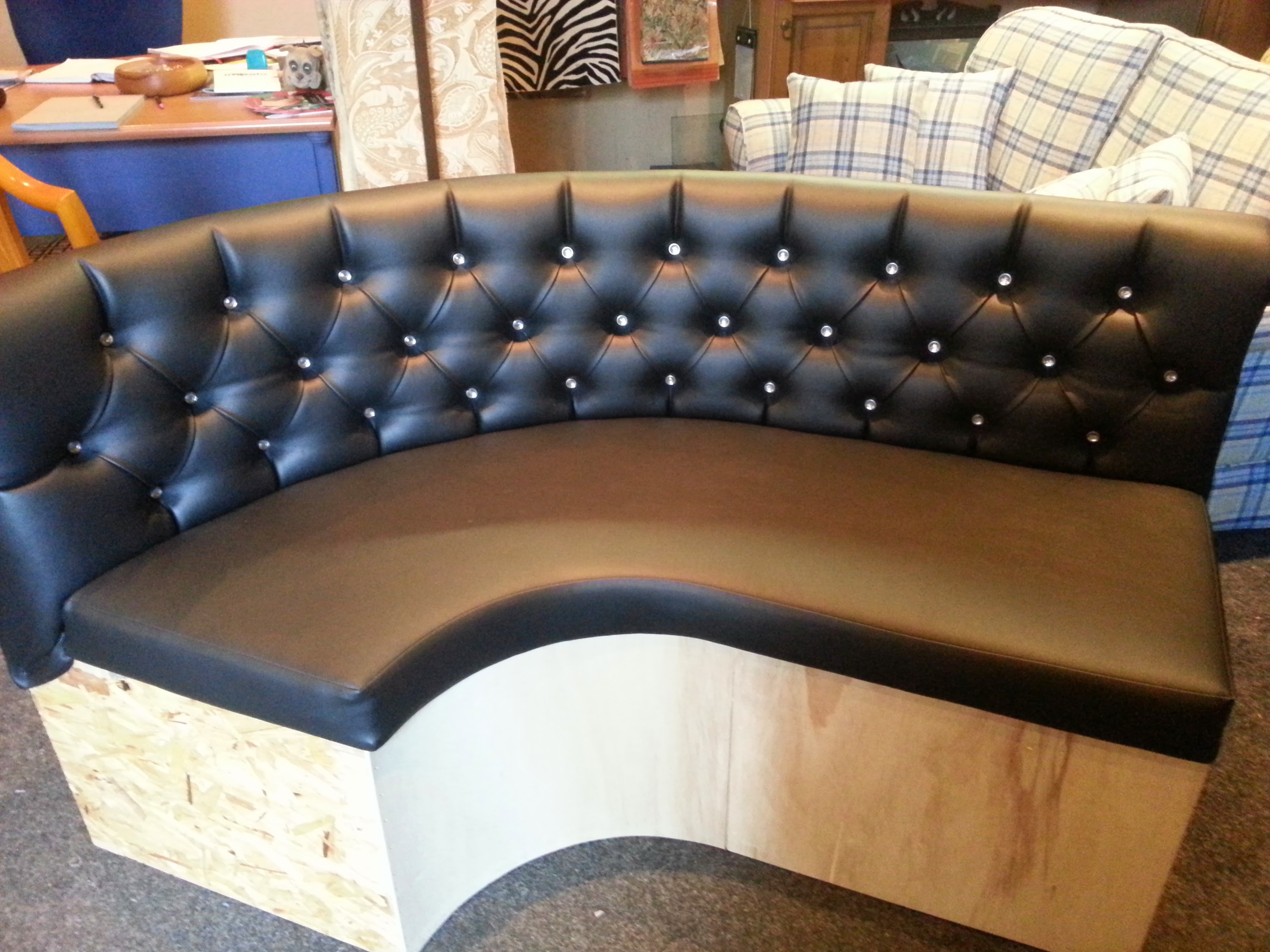 Black leather curved booth